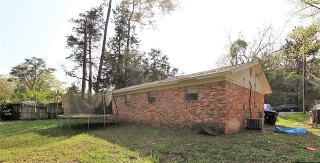 a backyard of a house with barbeque oven and outdoor seating