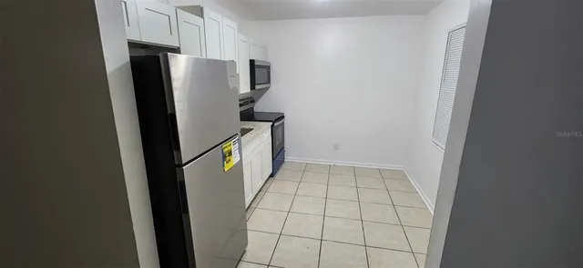 a view of a kitchen from a hallway