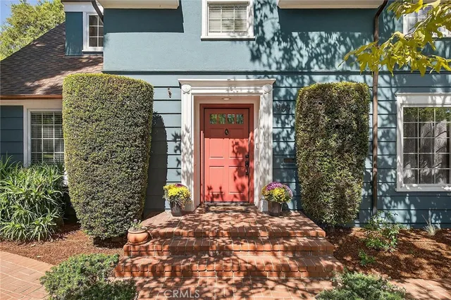 a view of a house with potted plants