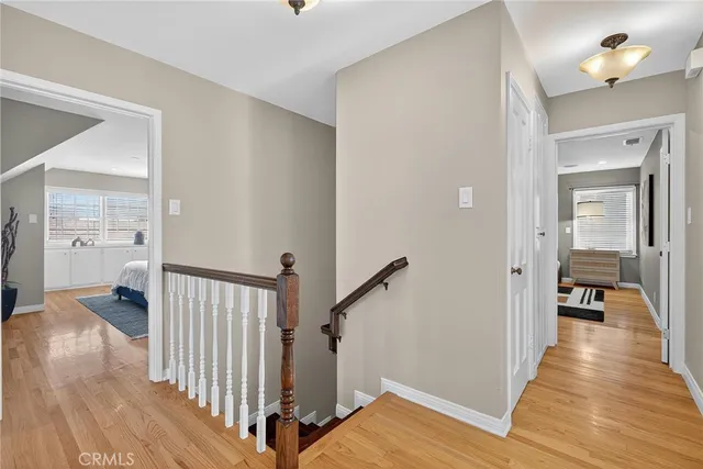 a bedroom with a bed and a large window with stairs