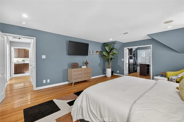 a bedroom with a bed and a flat screen tv