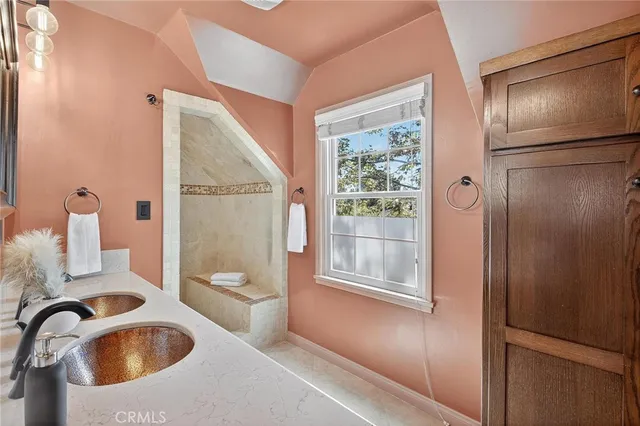 a view of a patio with couches table and chairs under an umbrella