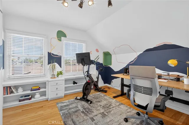 a view of a patio with table and chairs under an umbrella