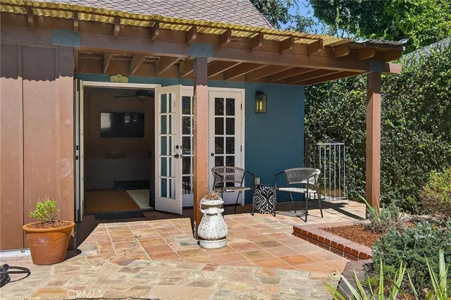 a view of a backyard with plants and a patio