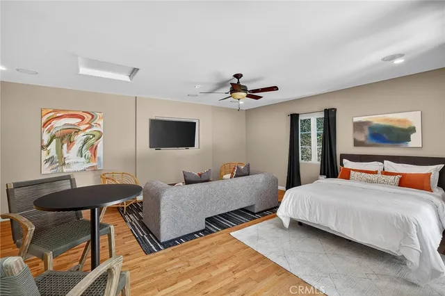 a view of a patio with table and chairs potted plants and a large tree