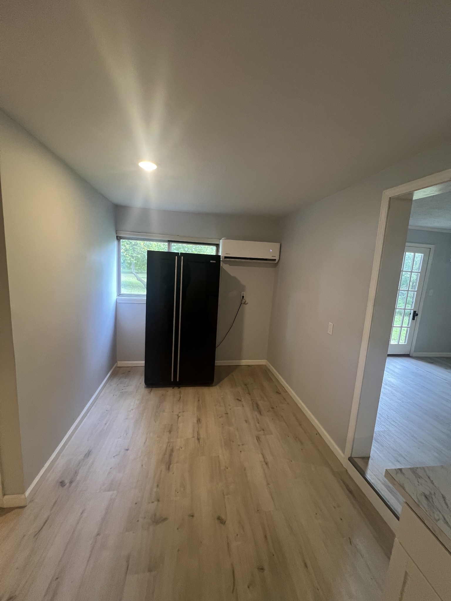 161 Woodlawn Road Pulaski, TN 38478 - Photo 12 of 46 an empty room with wooden floor and cabinet