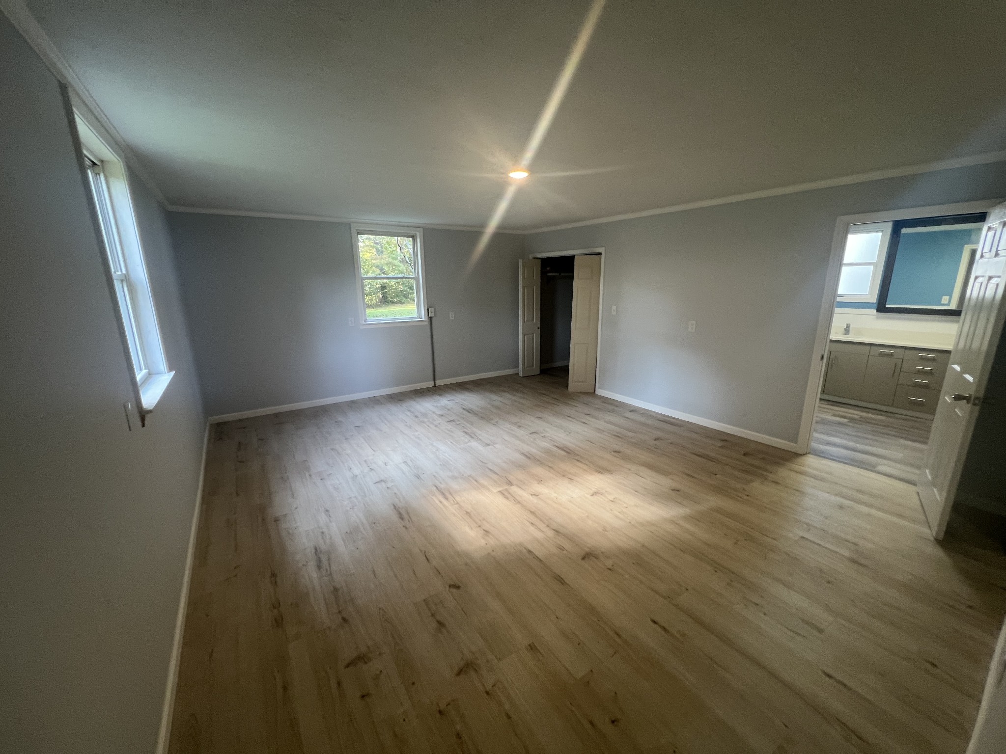 161 Woodlawn Road Pulaski, TN 38478 - Photo 18 of 46 an empty room with wooden floor and windows
