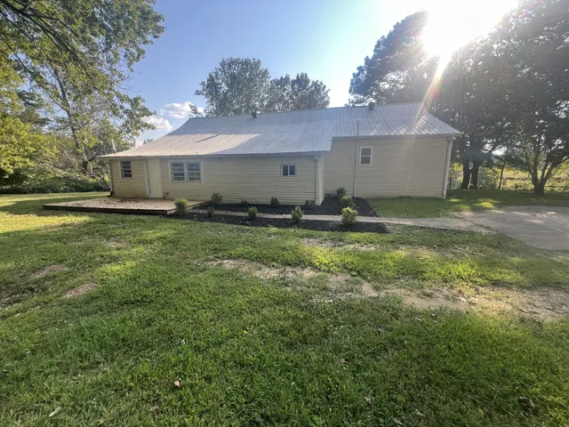 a backyard of a house with yard and garage