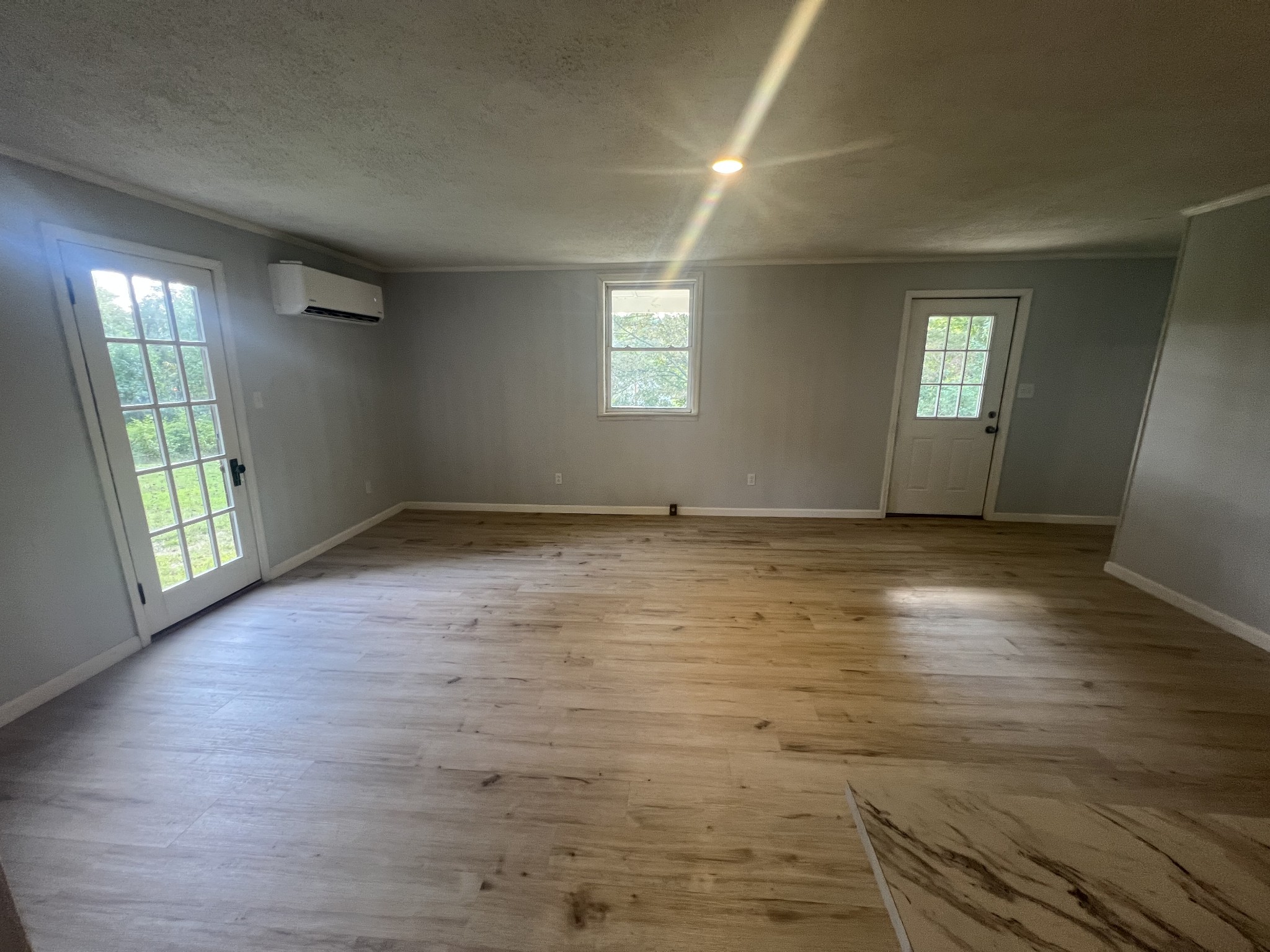 161 Woodlawn Road Pulaski, TN 38478 - Photo 6 of 46 an empty room with wooden floor and windows