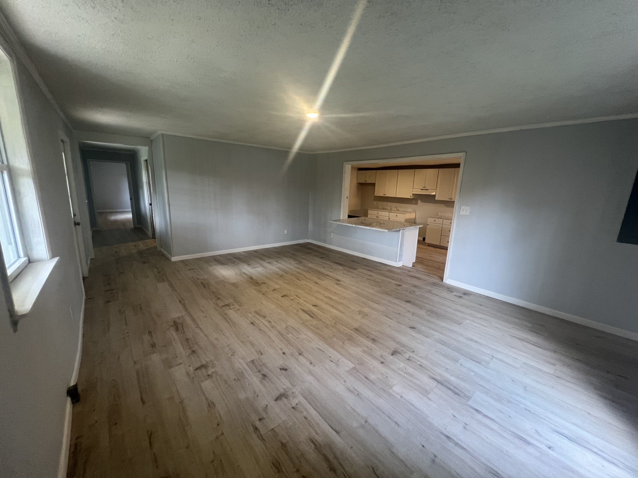 161 Woodlawn Road Pulaski, TN 38478 - Photo 7 of 46 an empty room with wooden floor and windows
