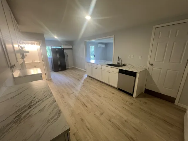a large room with wooden floor and windows