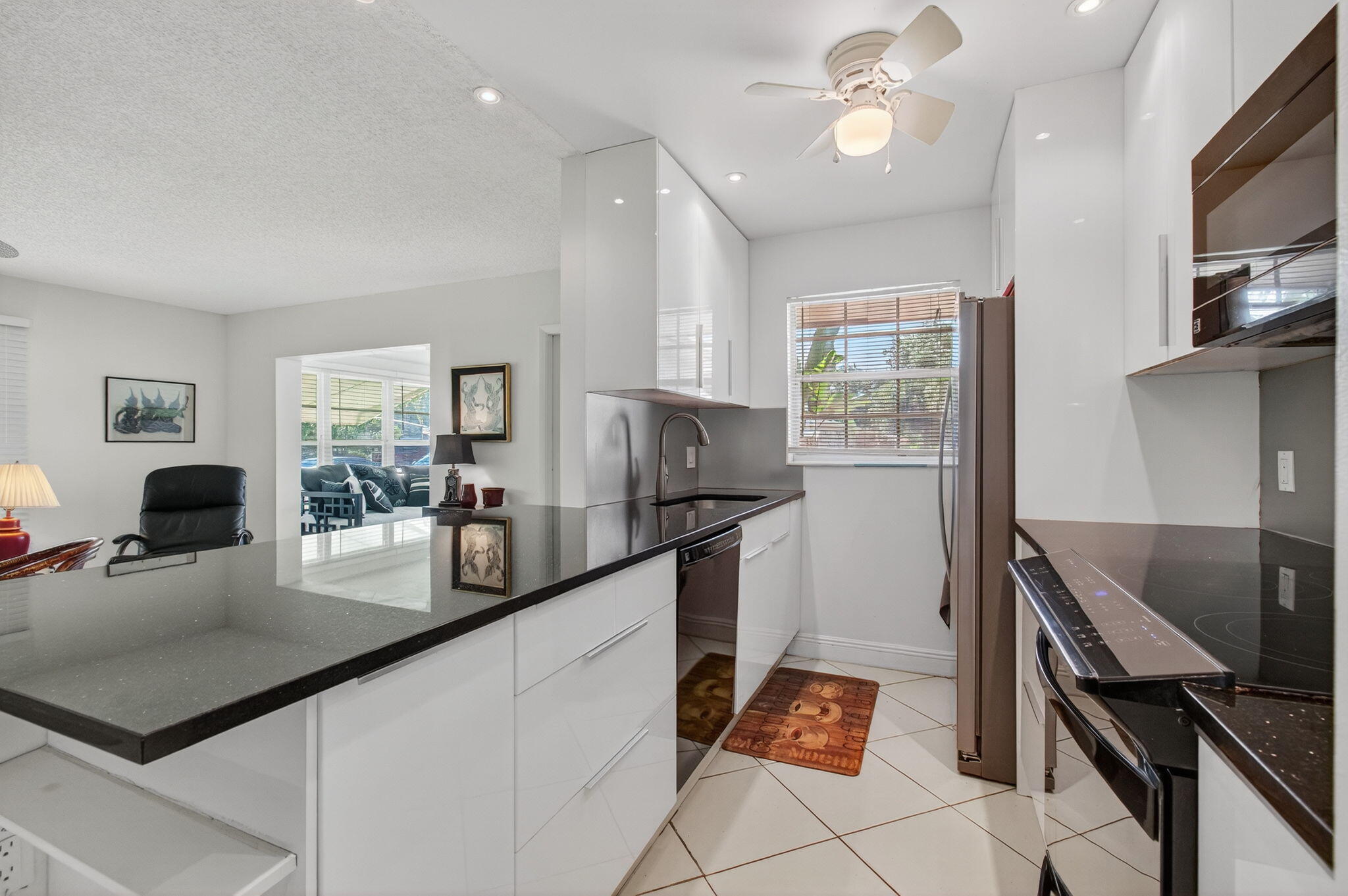 1305 High Point Way Southeast, Unit D Delray Beach, FL 33445 - Photo 16 of 53 a kitchen with granite countertop lots of counter top space