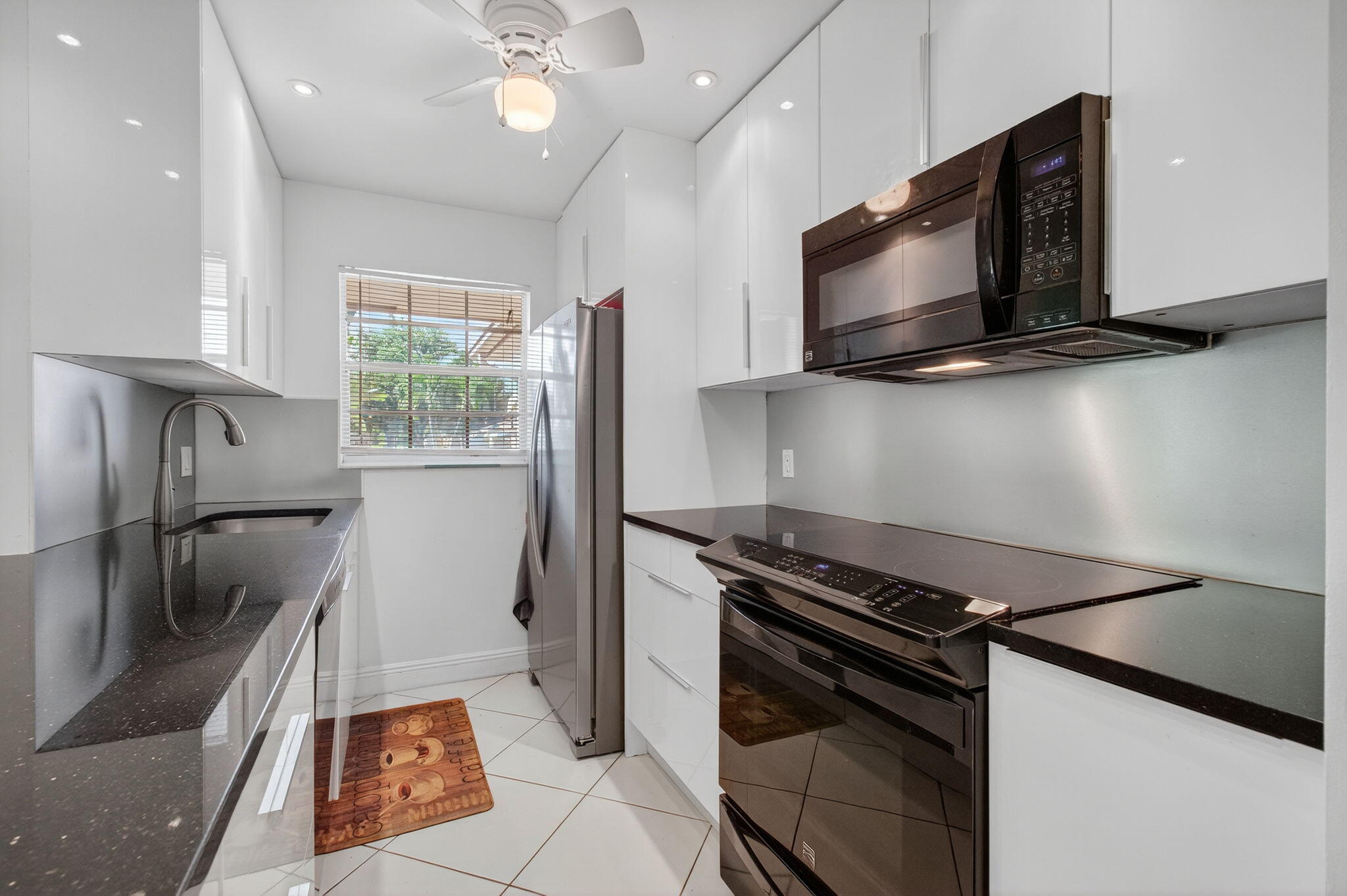 1305 High Point Way Southeast, Unit D Delray Beach, FL 33445 - Photo 18 of 53 a kitchen with a stove and a microwave