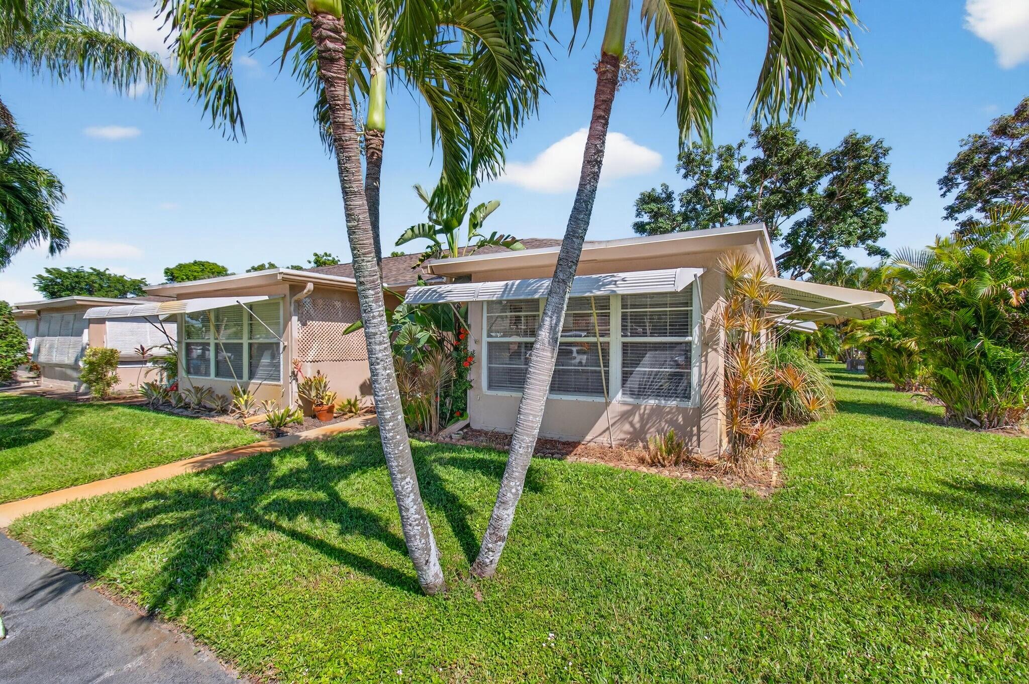 1305 High Point Way Southeast, Unit D Delray Beach, FL 33445 - Photo 2 of 53 a view of a house with a yard and sitting area