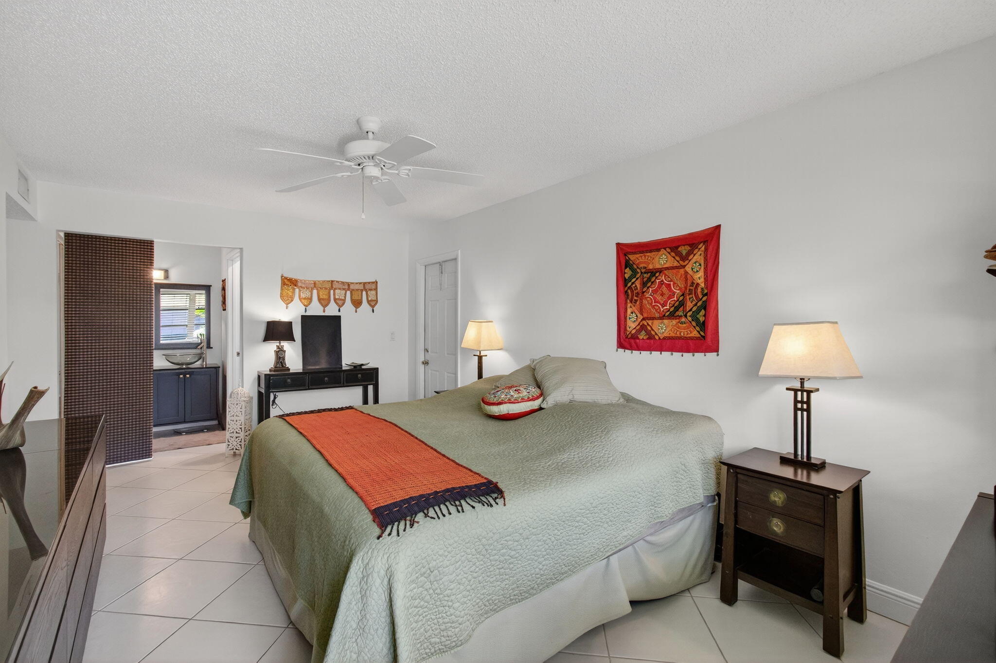 1305 High Point Way Southeast, Unit D Delray Beach, FL 33445 - Photo 30 of 53 a bed room with a bed and a lamp