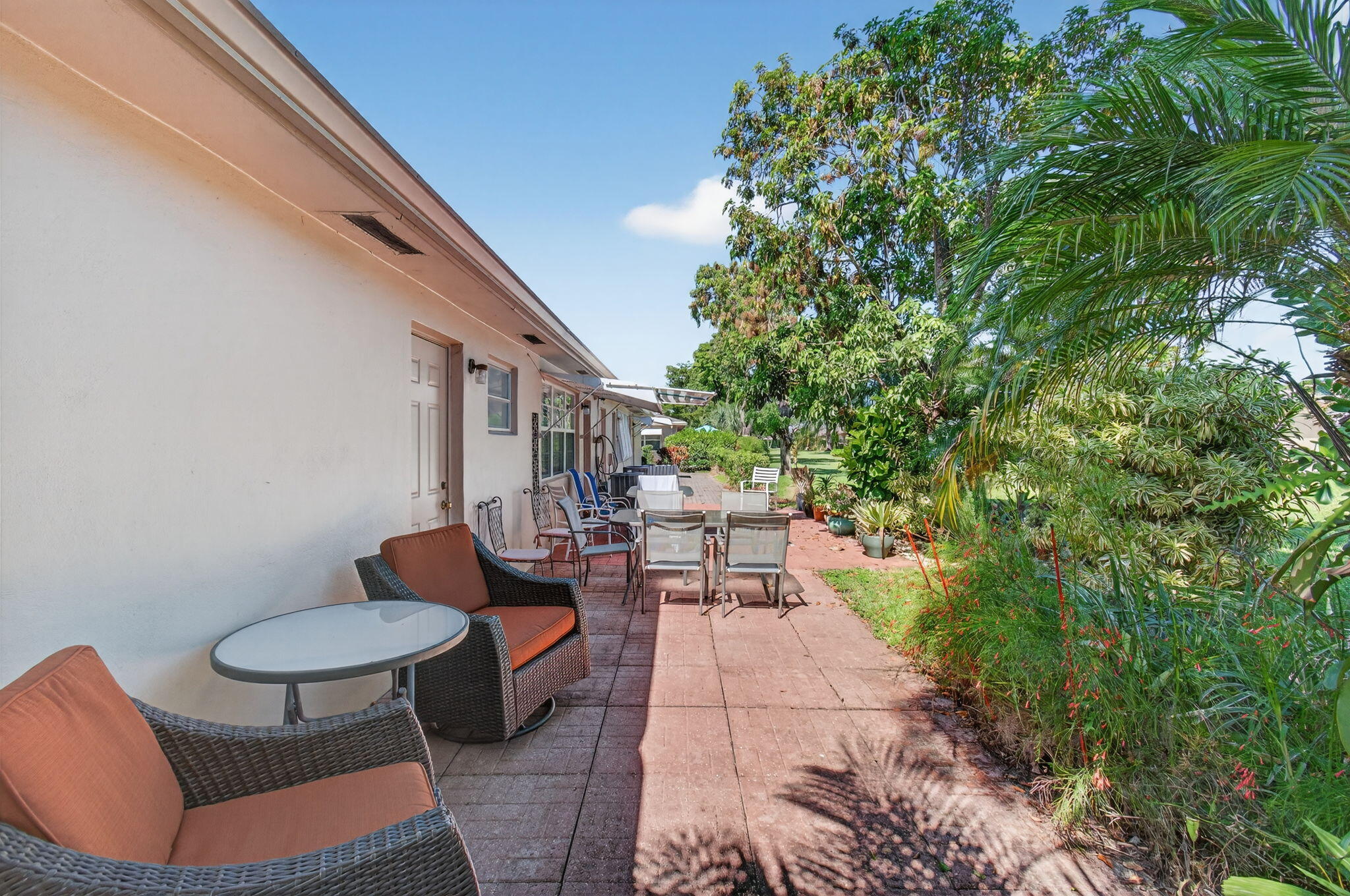 1305 High Point Way Southeast, Unit D Delray Beach, FL 33445 - Photo 31 of 53 a backyard of a house with table and chairs