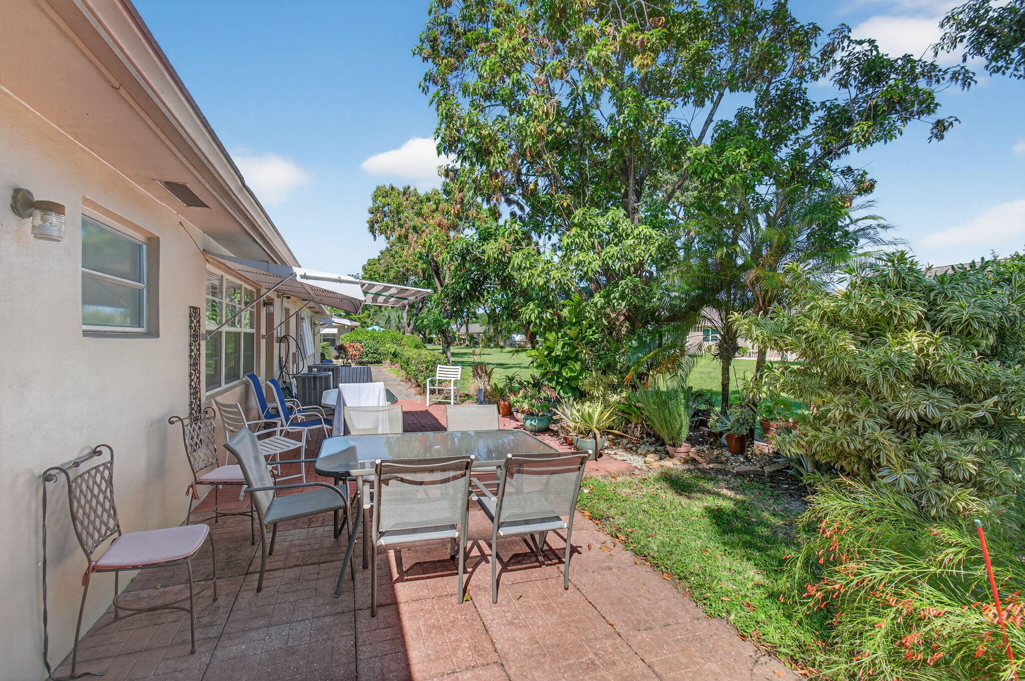 1305 High Point Way Southeast, Unit D Delray Beach, FL 33445 - Photo 32 of 53 a view of a patio with table and chairs and potted plants