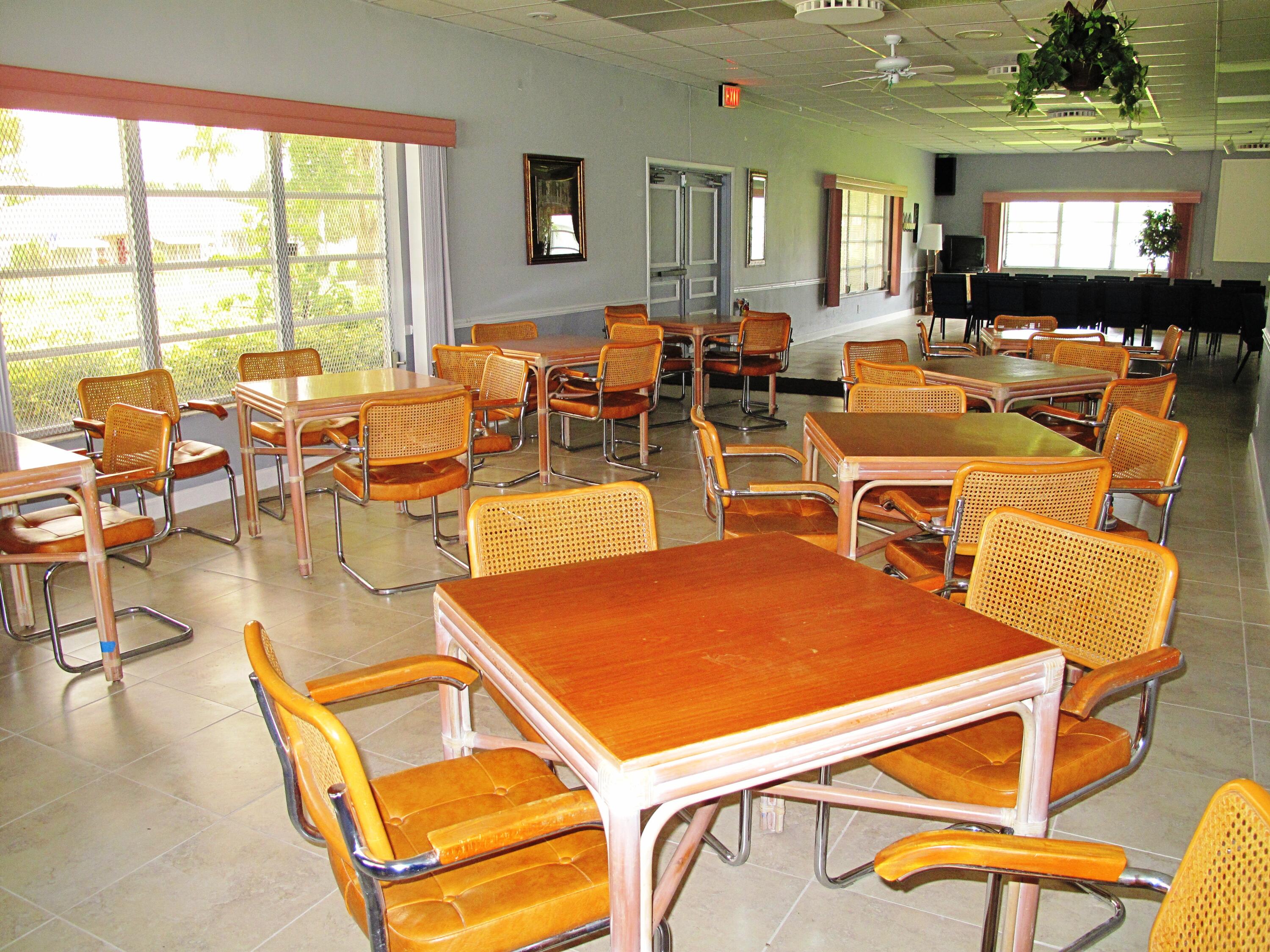 1305 High Point Way Southeast, Unit D Delray Beach, FL 33445 - Photo 45 of 53 a living room with lots of furniture and a floor to ceiling window