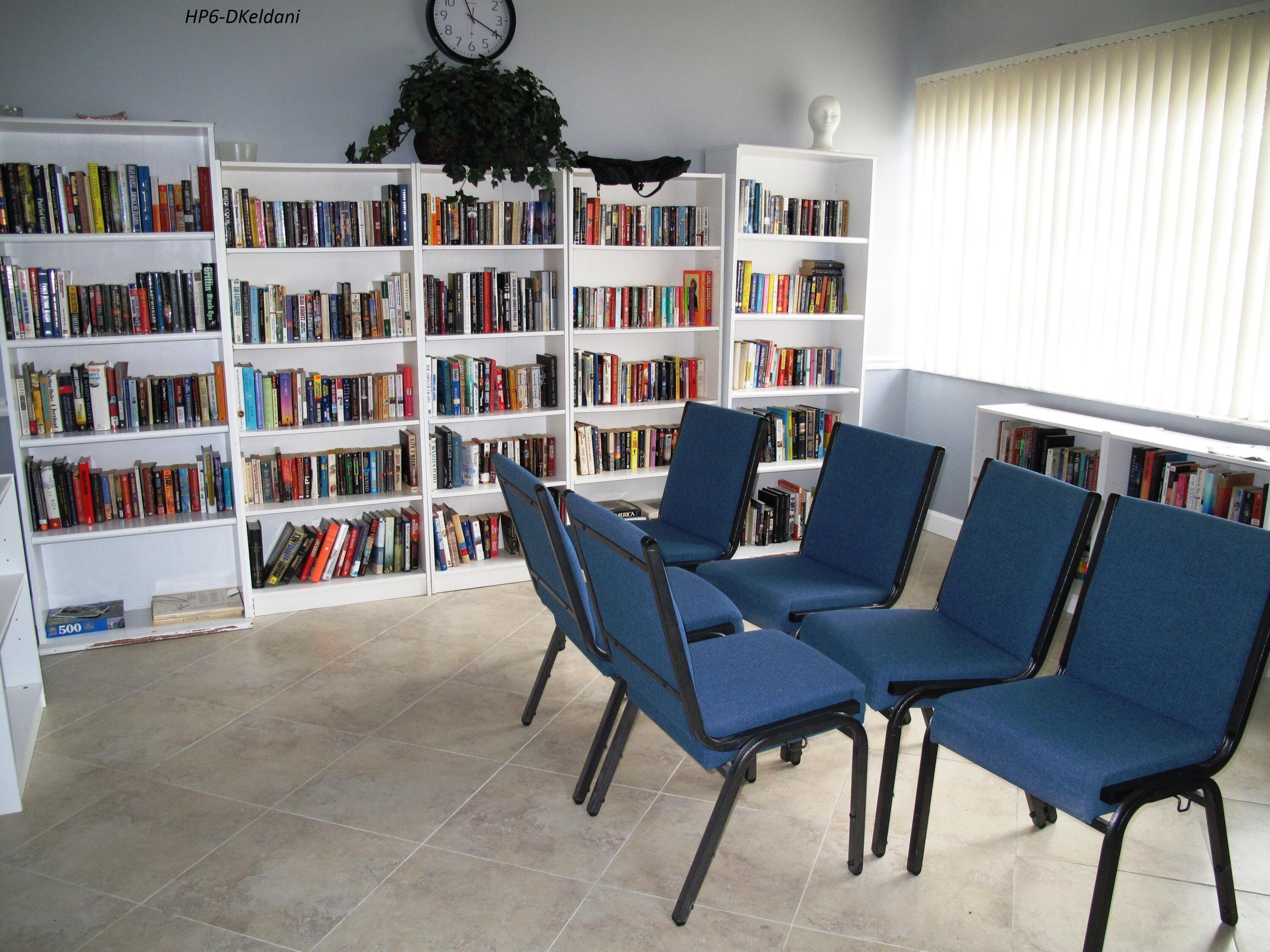 1305 High Point Way Southeast, Unit D Delray Beach, FL 33445 - Photo 47 of 53 a view of a workspace with furniture and a bookshelf