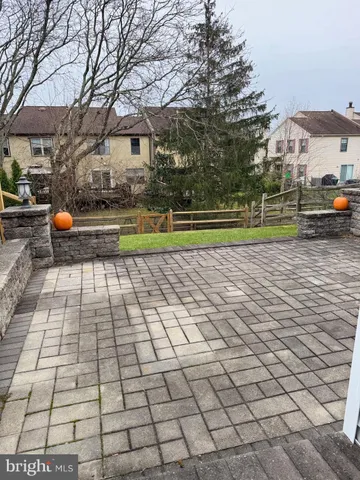 a utility room with a sink and wooden floor