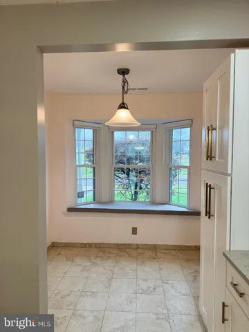 a view of a hallway to a window