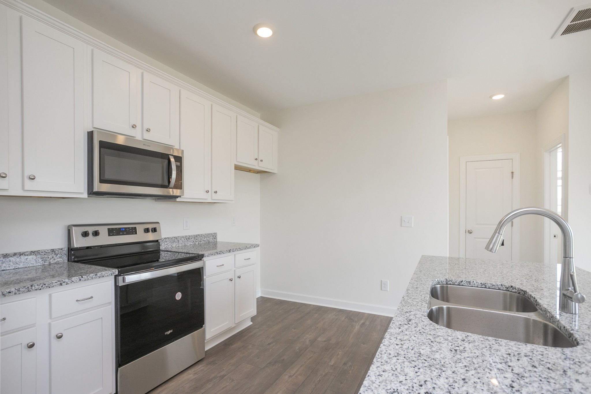 6008 Cavalry Ct Spring Hill Spring Hill, TN 37174 - Photo 22 of 42 a kitchen with stainless steel appliances granite countertop a sink a stove a microwave and cabinets