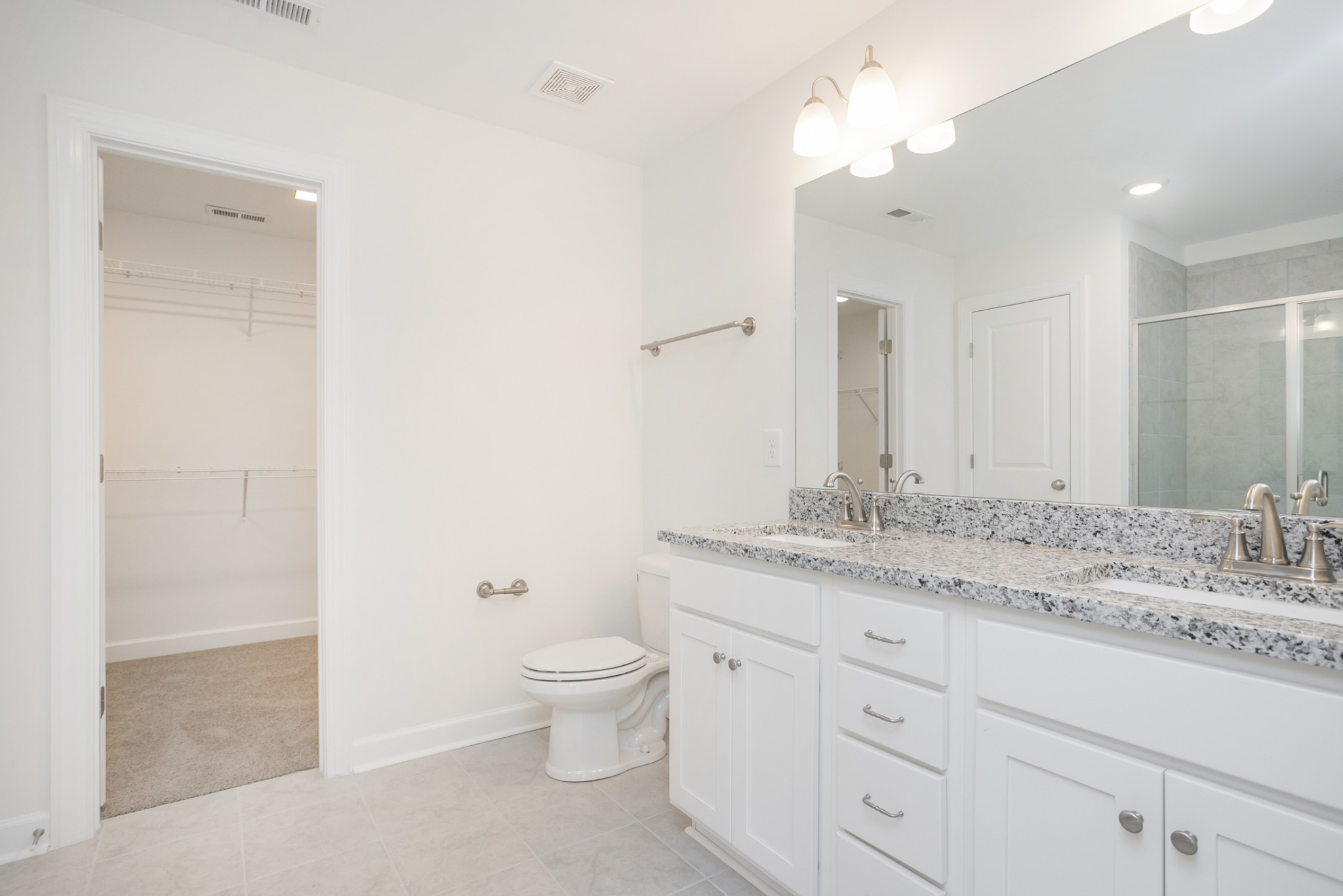 6008 Cavalry Ct Spring Hill Spring Hill, TN 37174 - Photo 27 of 42 a bathroom with a granite countertop sink a toilet and a mirror