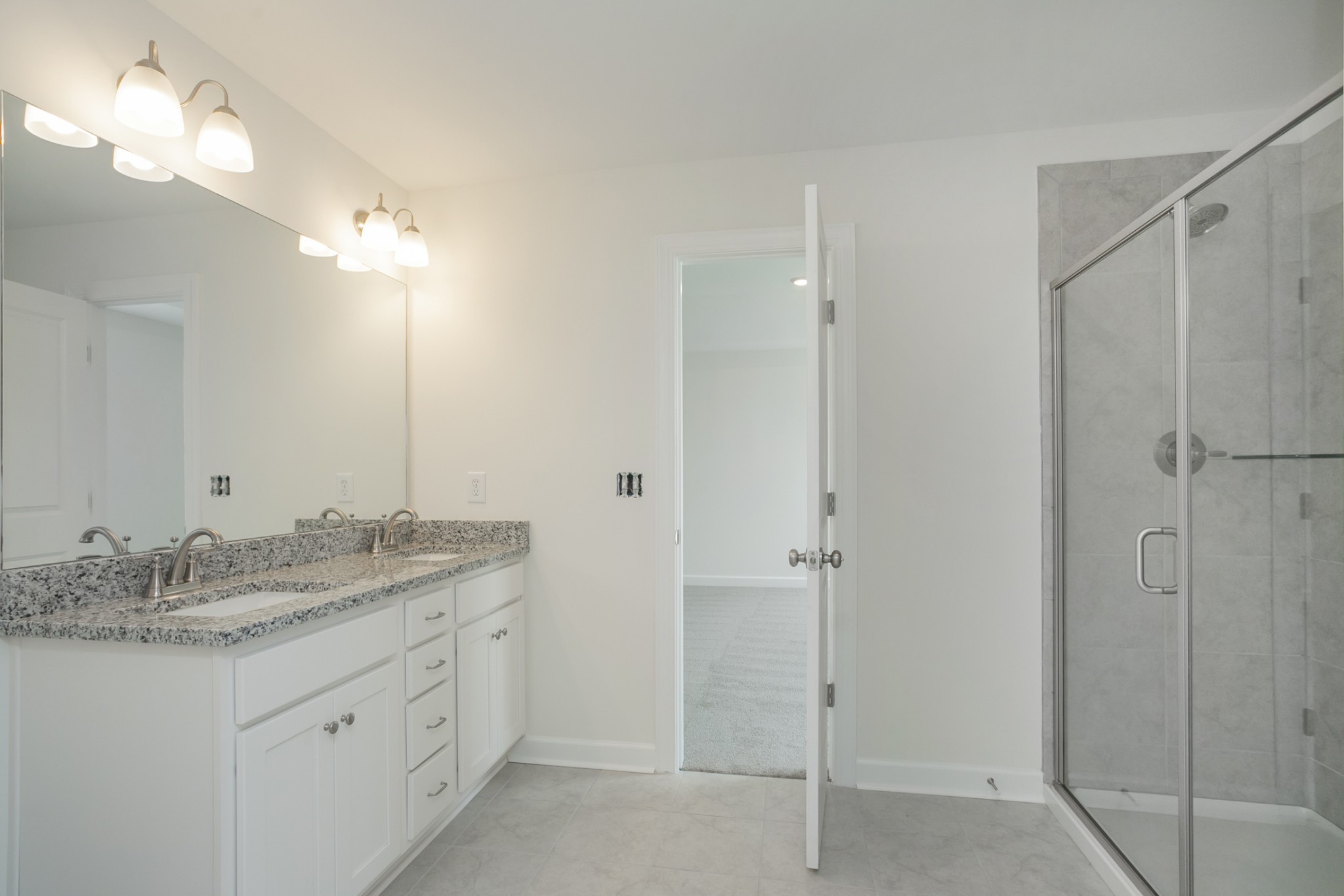 6008 Cavalry Ct Spring Hill Spring Hill, TN 37174 - Photo 29 of 42 a bathroom with a granite countertop sink two mirror and shower