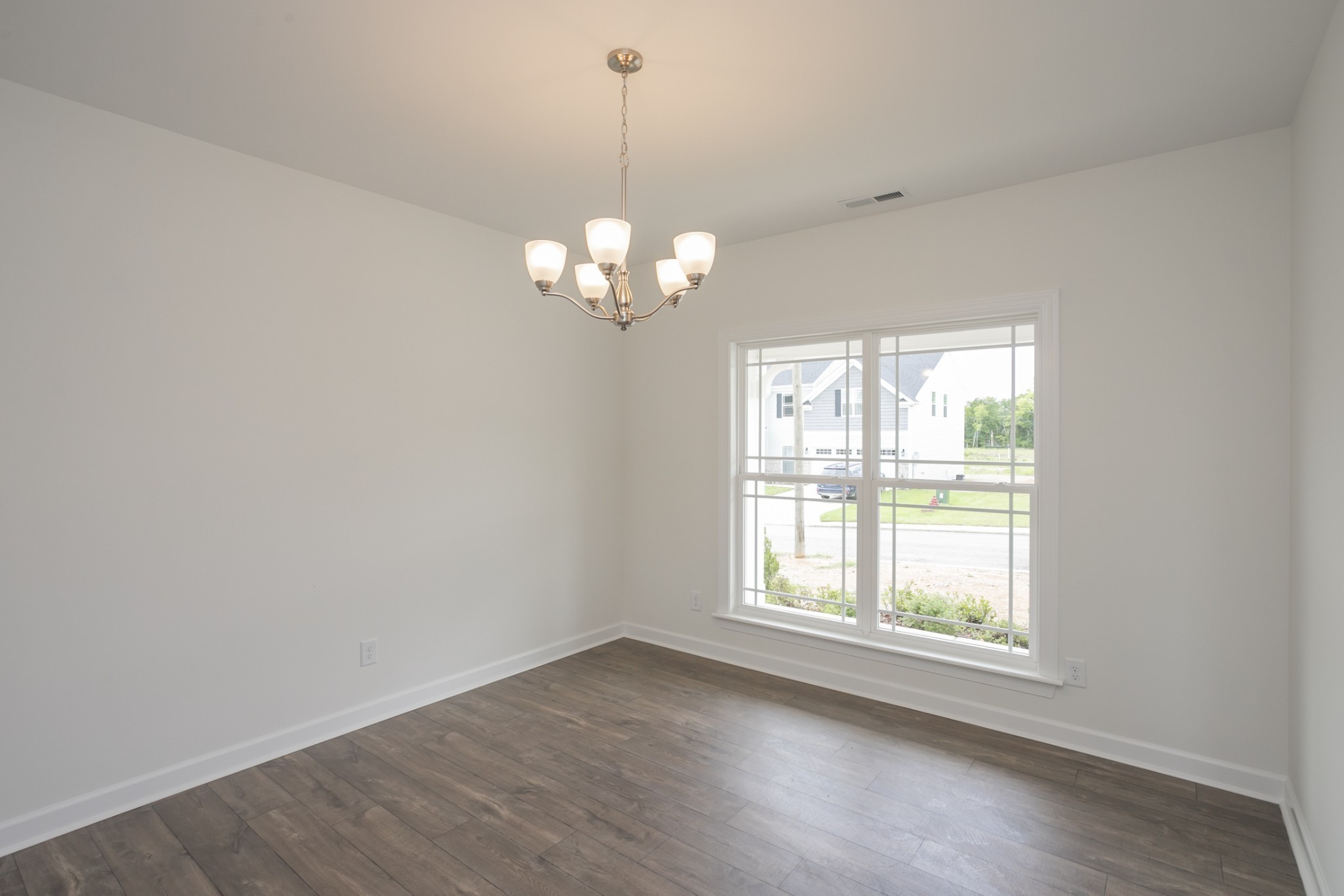 6008 Cavalry Ct Spring Hill Spring Hill, TN 37174 - Photo 7 of 42 an empty room with wooden floor and windows