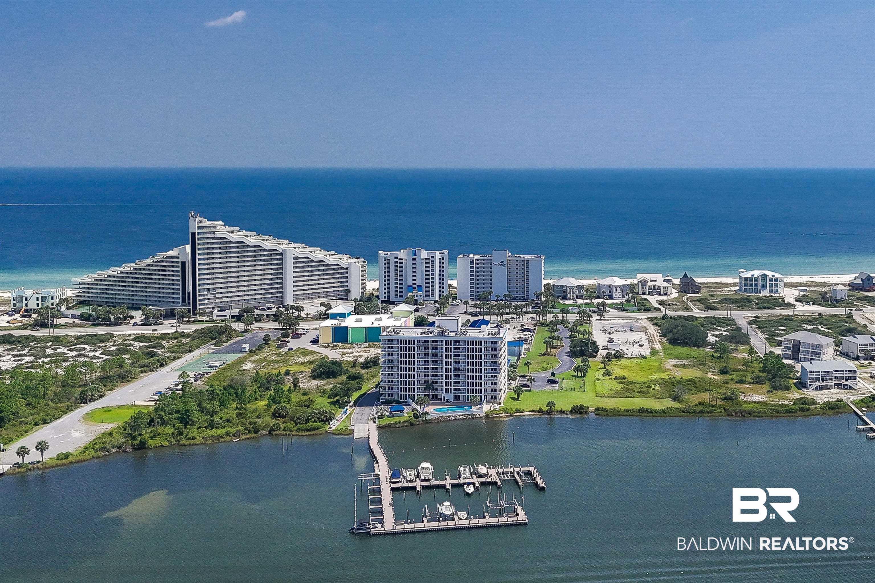 16287 Perdido Key Drive, Unit 105 Pensacola, FL 32507 - Photo 61 of 66 Coastal community featuring multiple high-rise condominium buildings, a private boat dock with multiple slips, and direct access to both bay and ocean waters