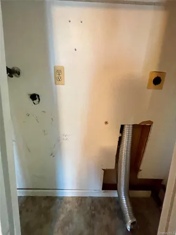 an empty room with a ceiling fan and window