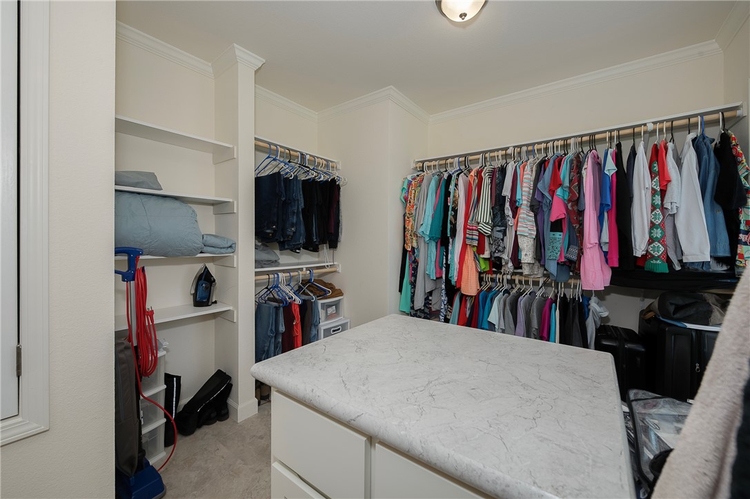 10976 Whiterock Road Bremond, TX 76629 - Photo 17 of 42 a view of walk in closet with clothes and shoes