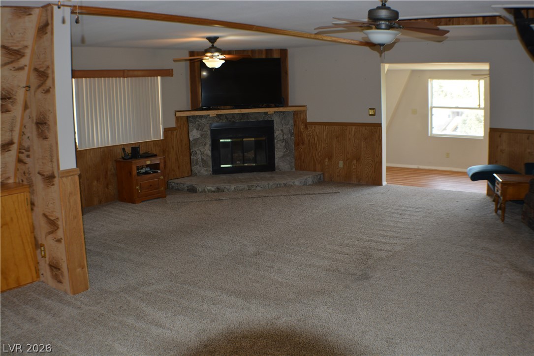1321 Trout Canyon Road Las Vegas, NV 89124 - Photo 13 of 50 A spacious living area features a robust stone fireplace, ready for cozy evenings.