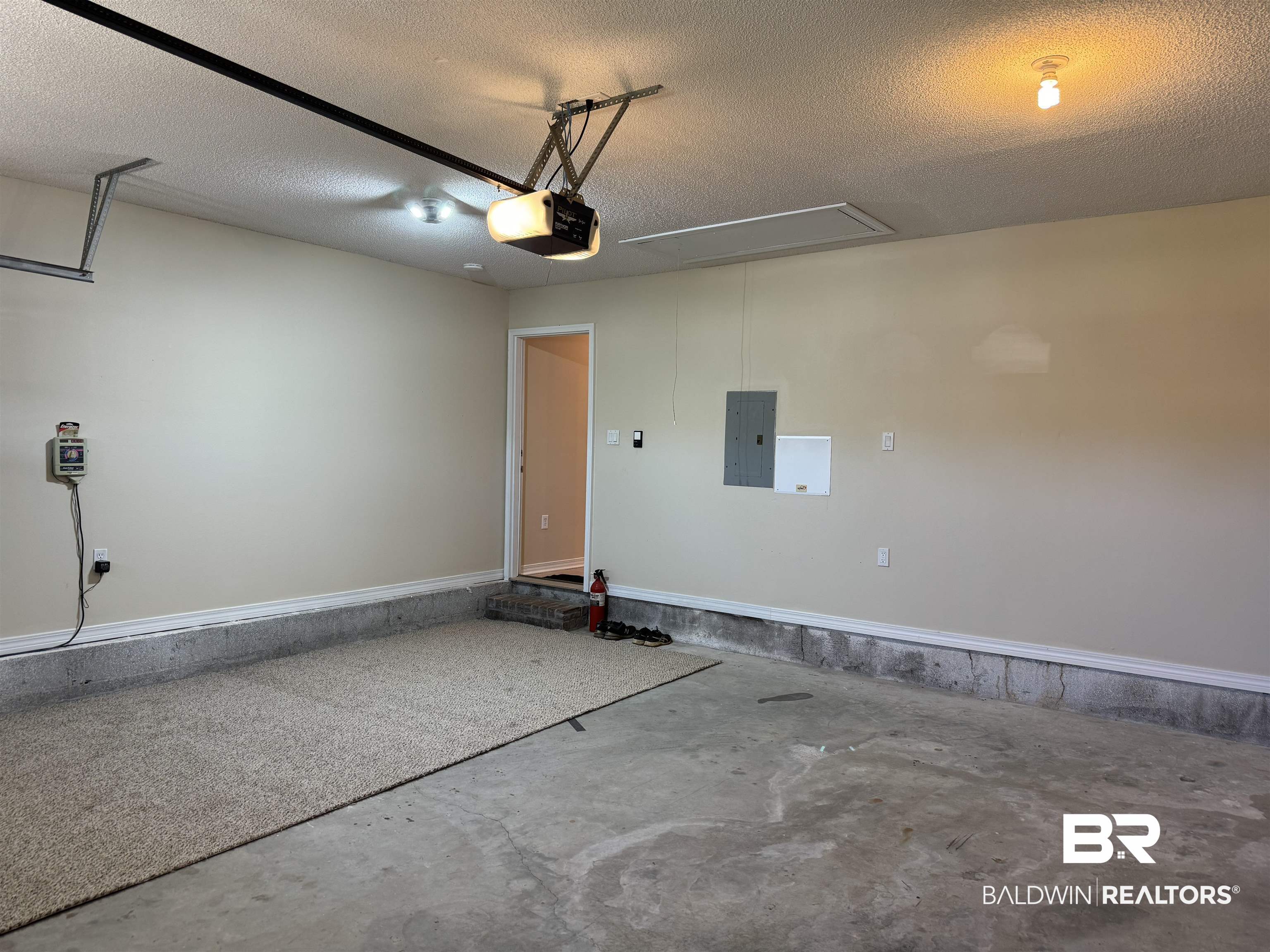 32769 Arbor Ridge Circle Lillian, AL 36549 - Photo 27 of 36 Garage with electric panel and a garage door opener
