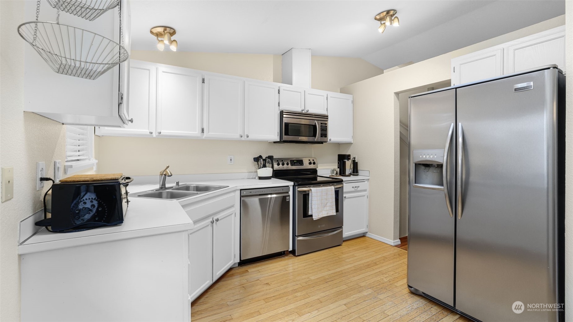 1232 220th Place Southwest Bothell, WA 98021 - Photo 5 of 24 a kitchen with a refrigerator a stove a microwave and cabinets