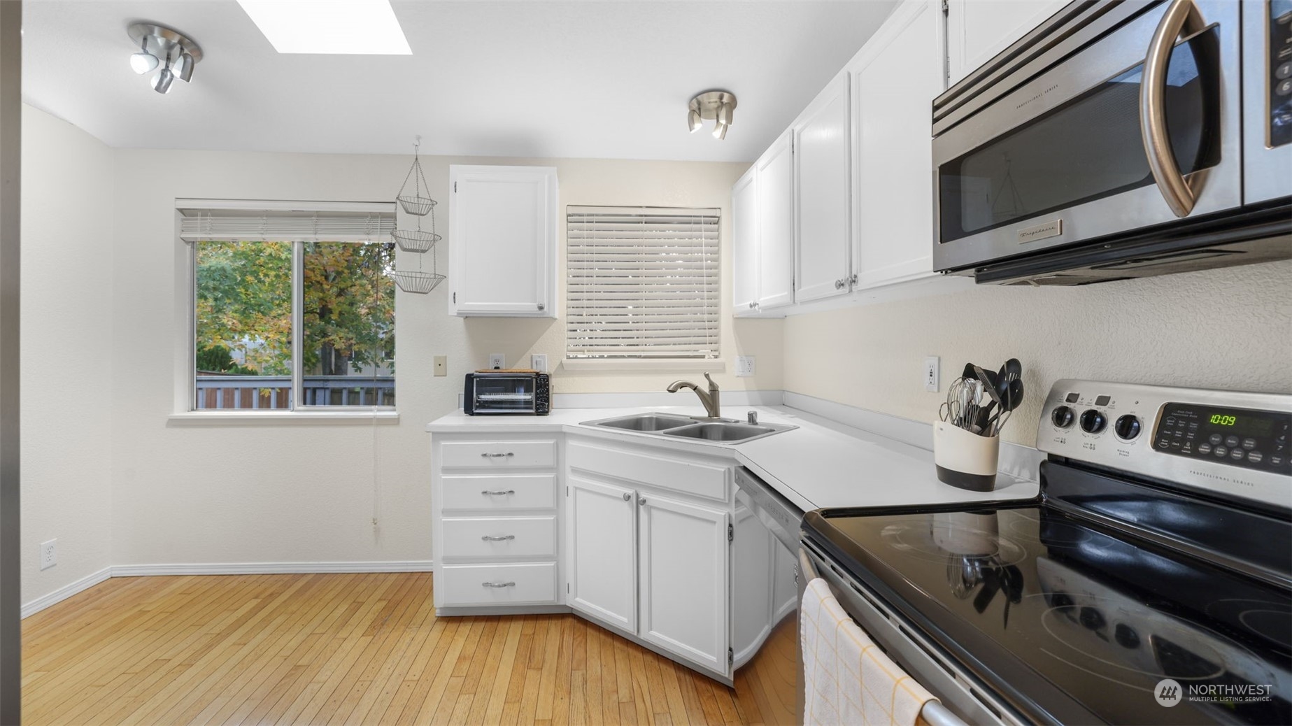 1232 220th Place Southwest Bothell, WA 98021 - Photo 6 of 24 a kitchen with a sink stove top oven and cabinets
