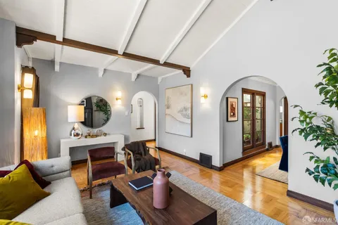 a living room with fireplace furniture and decor