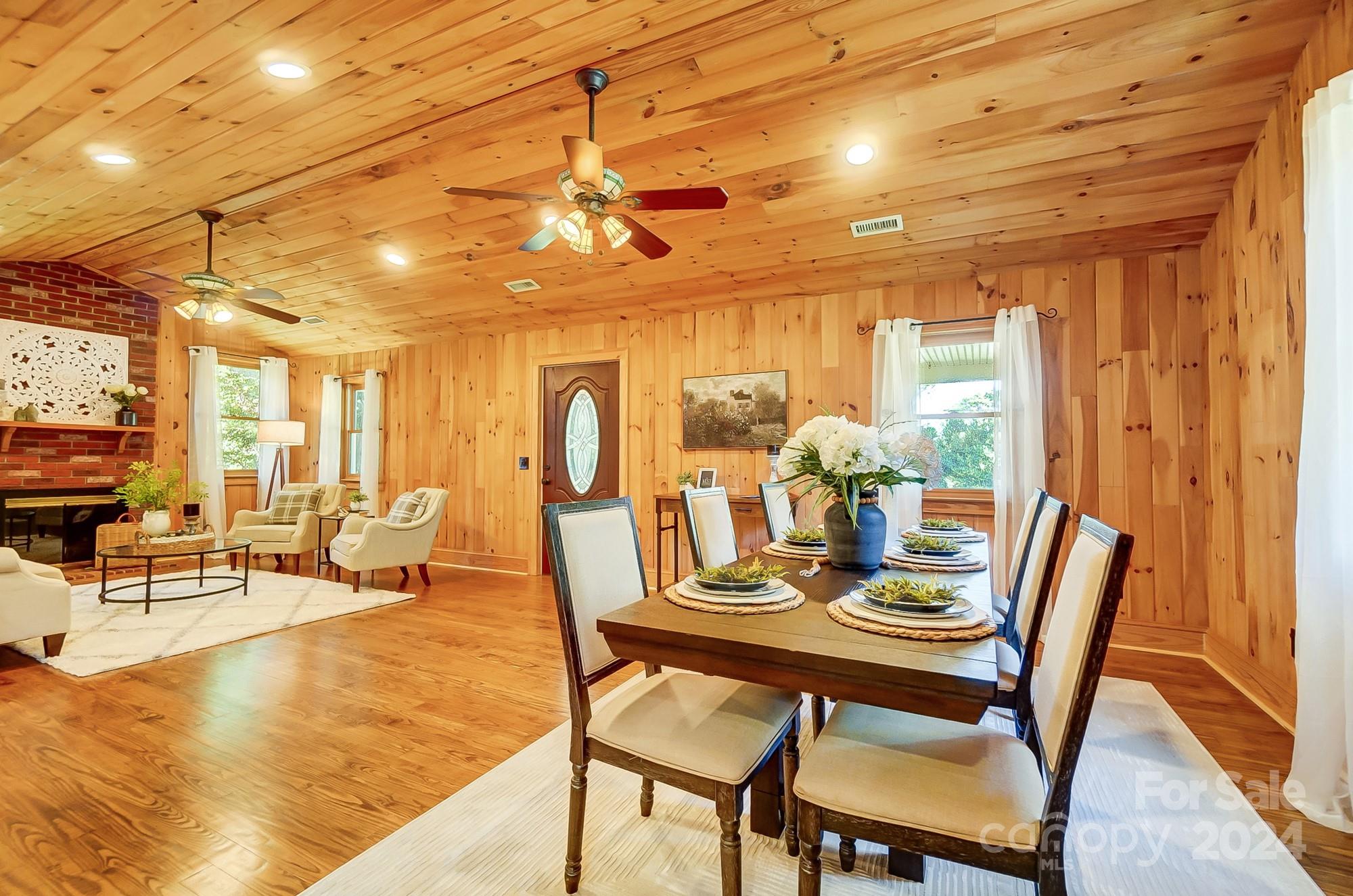 6338 Talley Road Stanfield, NC 28163 - Photo 12 of 48 a dining room with furniture a chandelier and wooden floor