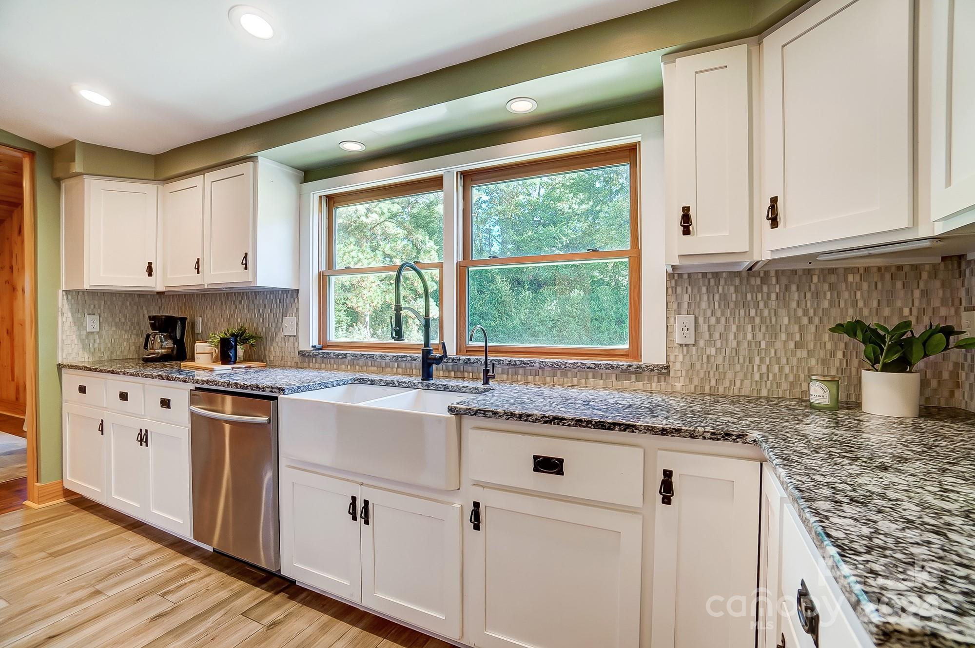 6338 Talley Road Stanfield, NC 28163 - Photo 15 of 48 a kitchen with granite countertop white cabinets and white stainless steel appliances with a sink