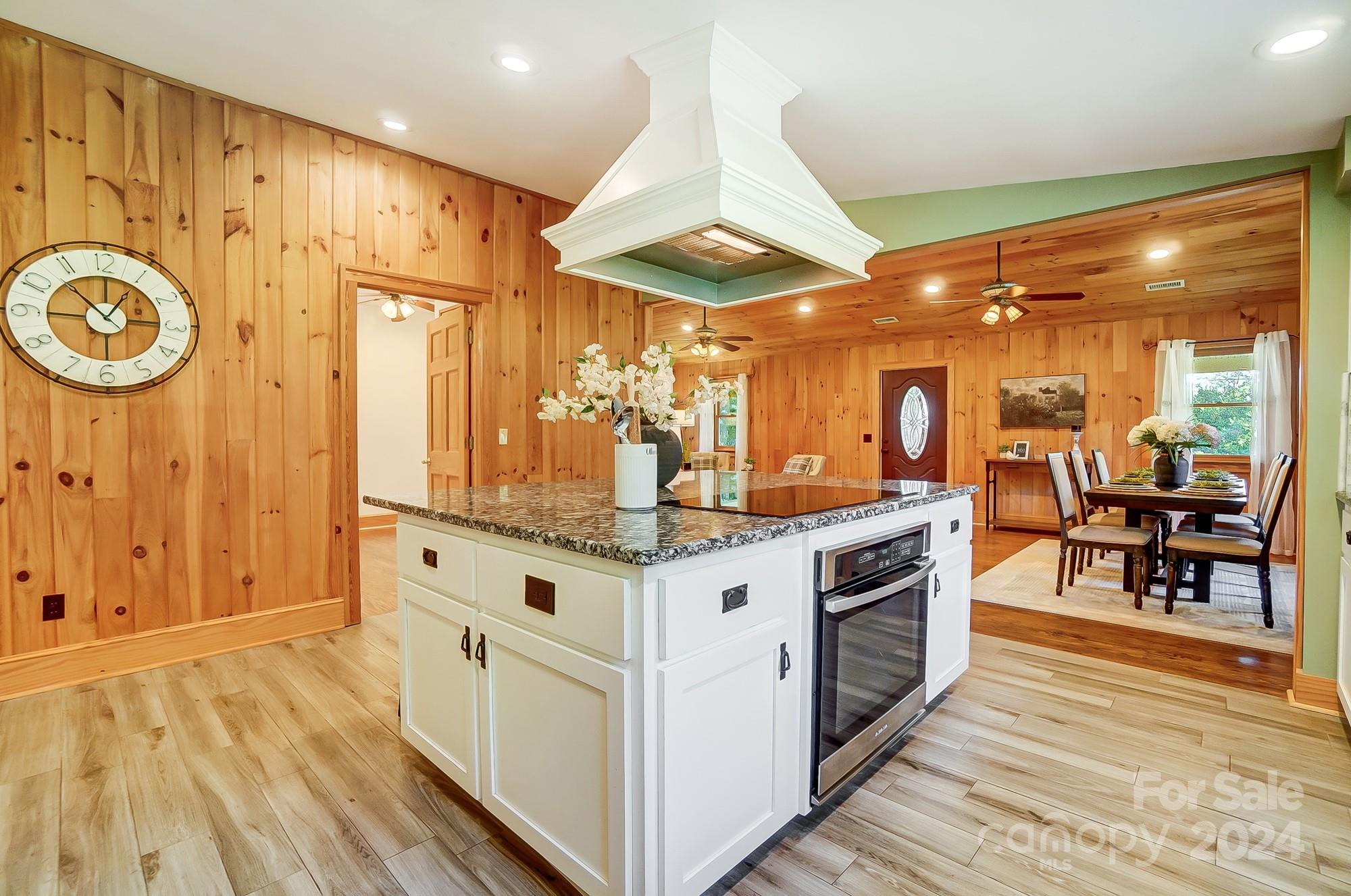 6338 Talley Road Stanfield, NC 28163 - Photo 16 of 48 a kitchen with stainless steel appliances granite countertop a stove and a wooden floors