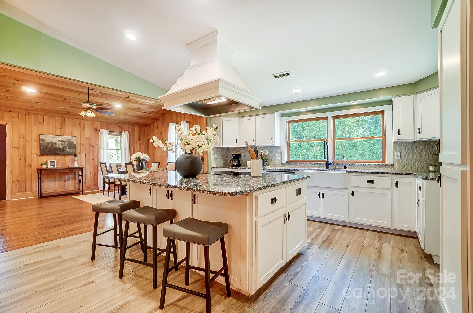 6338 Talley Road Stanfield, NC 28163 - Photo 17 of 48 a kitchen with stainless steel appliances granite countertop wooden floors and white cabinets