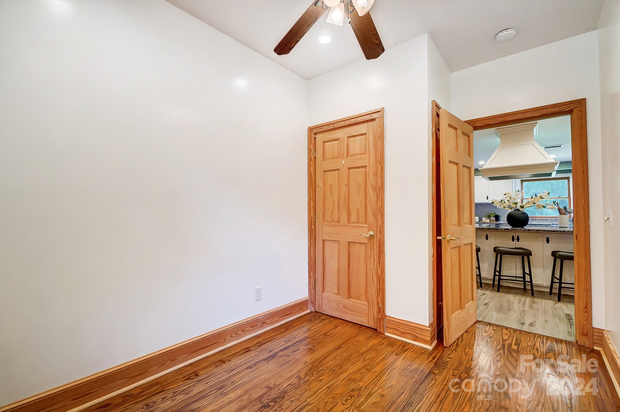 6338 Talley Road Stanfield, NC 28163 - Photo 19 of 48 a view of a livingroom with wooden floor and a ceiling fan