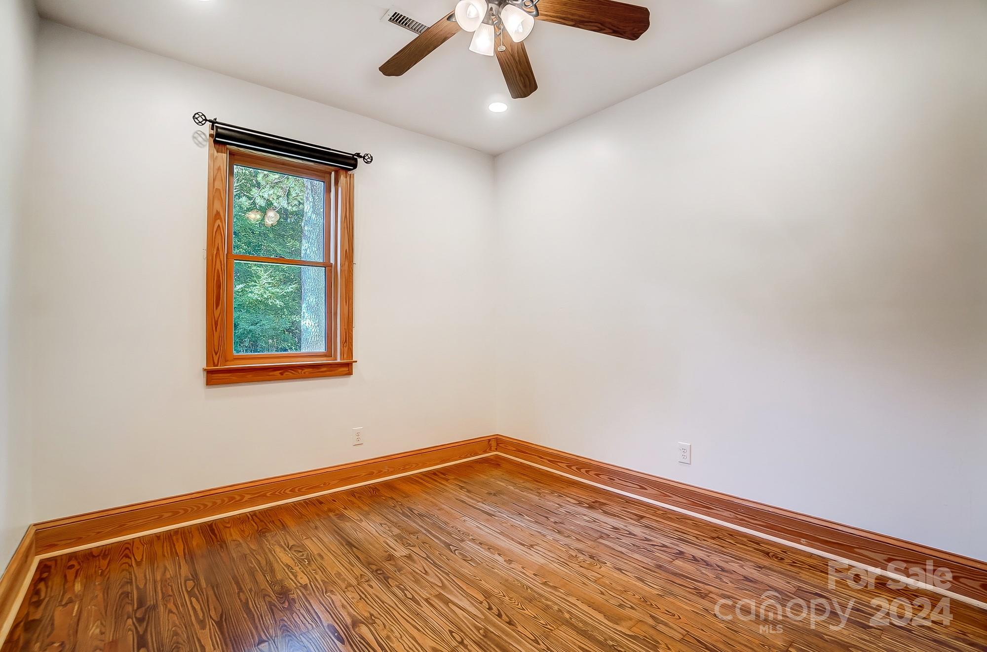 6338 Talley Road Stanfield, NC 28163 - Photo 23 of 48 wooden floor in an empty room with a window