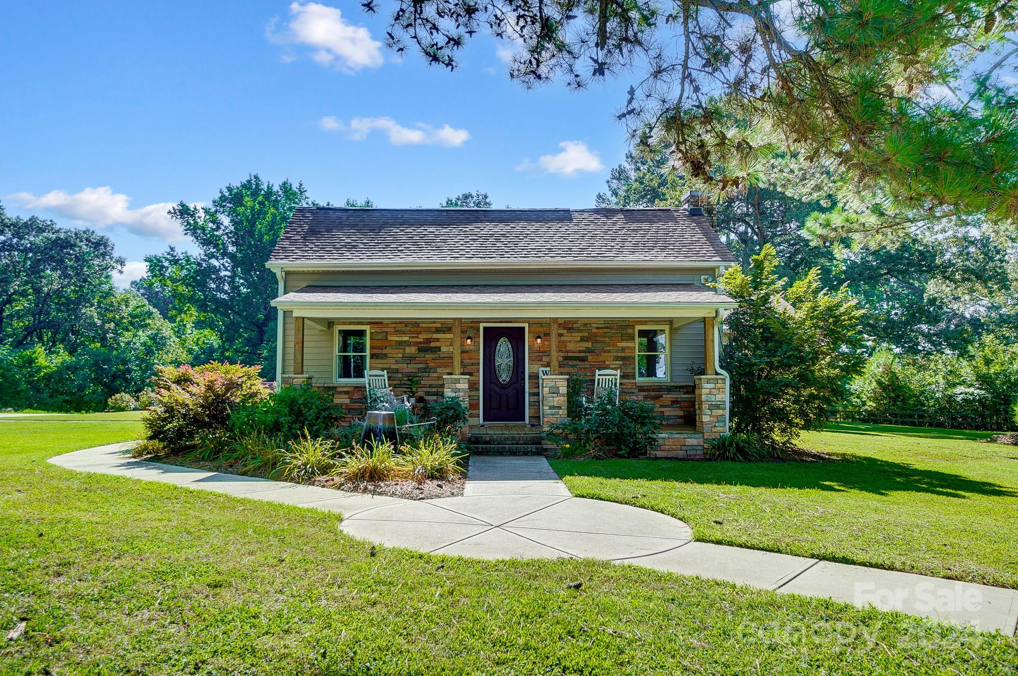 6338 Talley Road Stanfield, NC 28163 - Photo 3 of 48 a view of a house with garden and plants