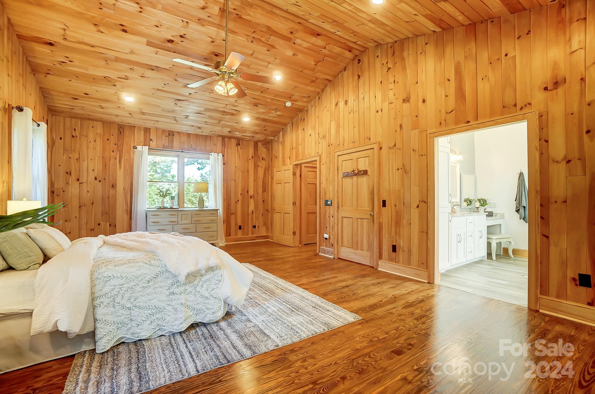6338 Talley Road Stanfield, NC 28163 - Photo 35 of 48 a spacious bedroom with a bed and wooden floor