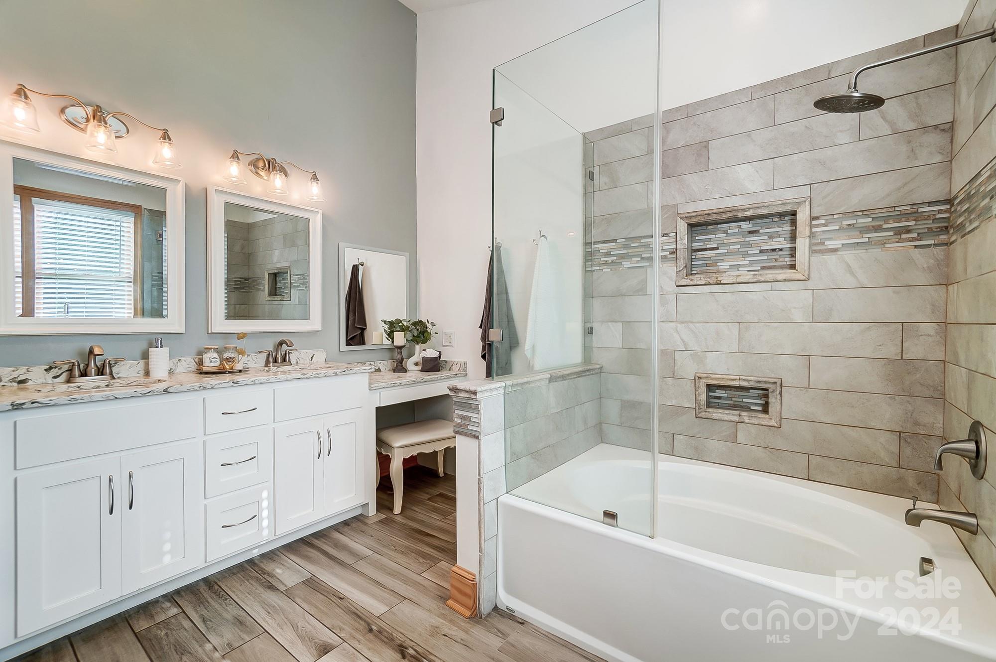 6338 Talley Road Stanfield, NC 28163 - Photo 39 of 48 a bathroom with a tub a sink and mirrors