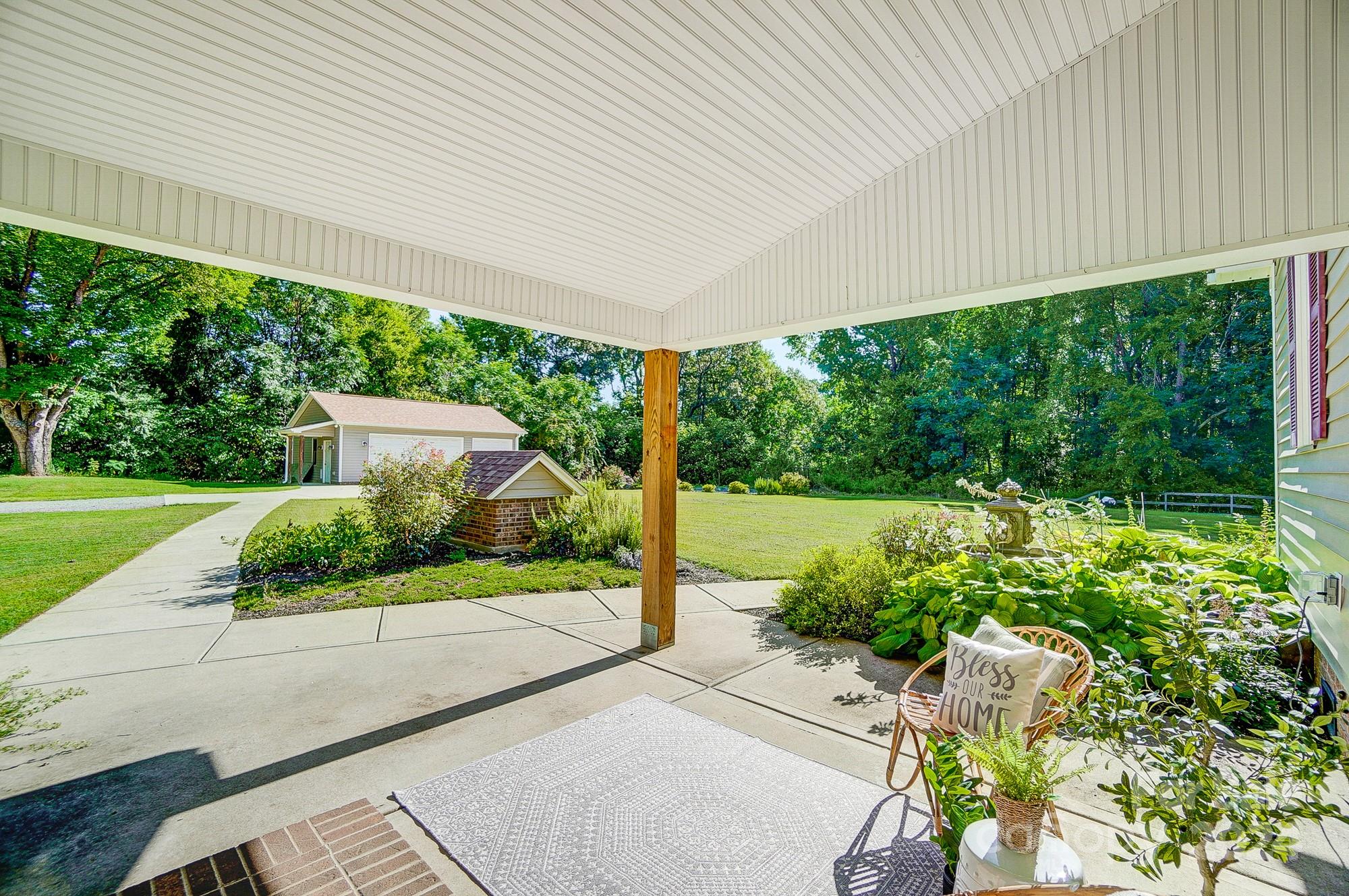 6338 Talley Road Stanfield, NC 28163 - Photo 43 of 48 a view of a garden with plants and large trees