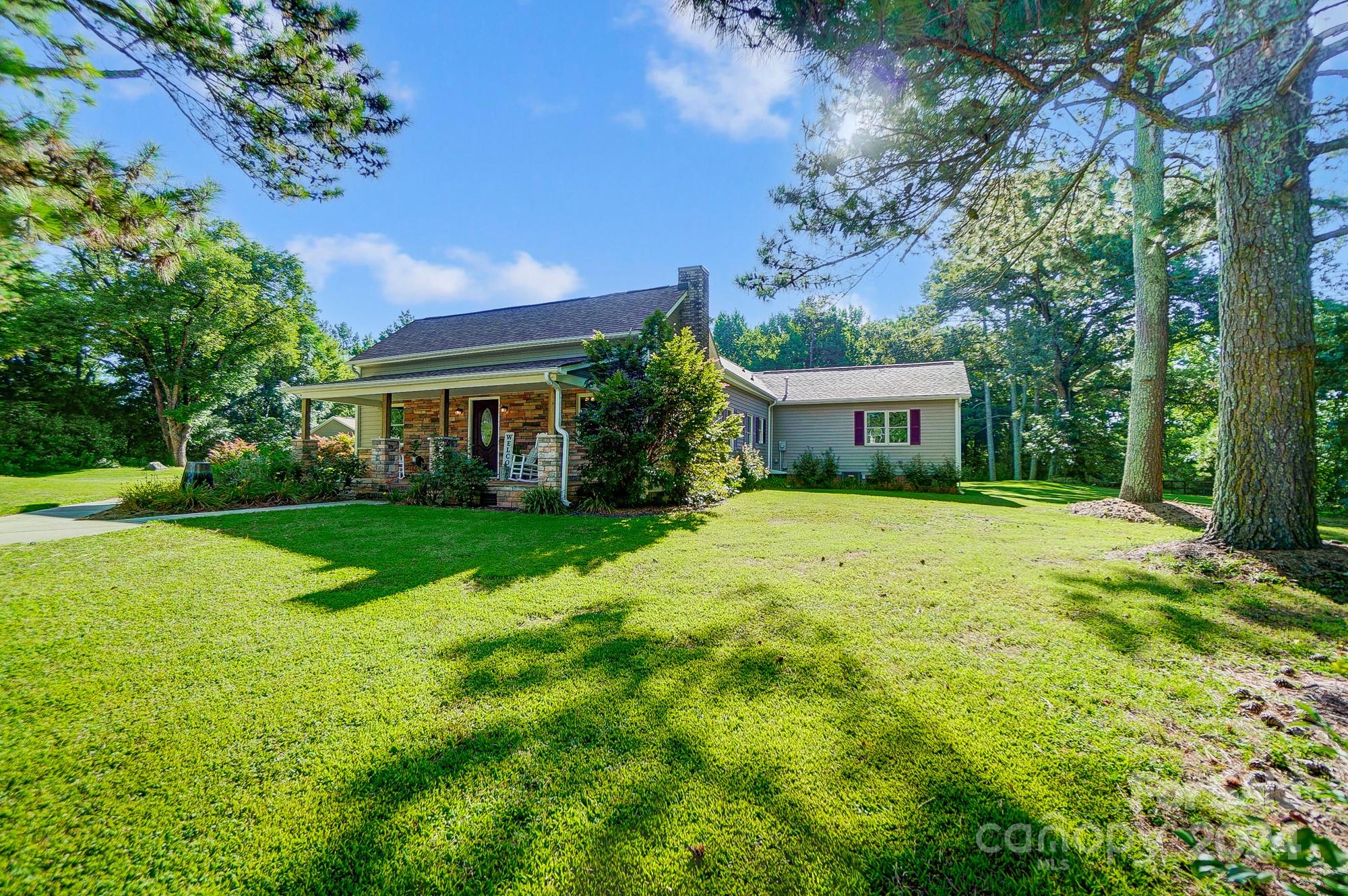 6338 Talley Road Stanfield, NC 28163 - Photo 5 of 48 a front view of a house with garden