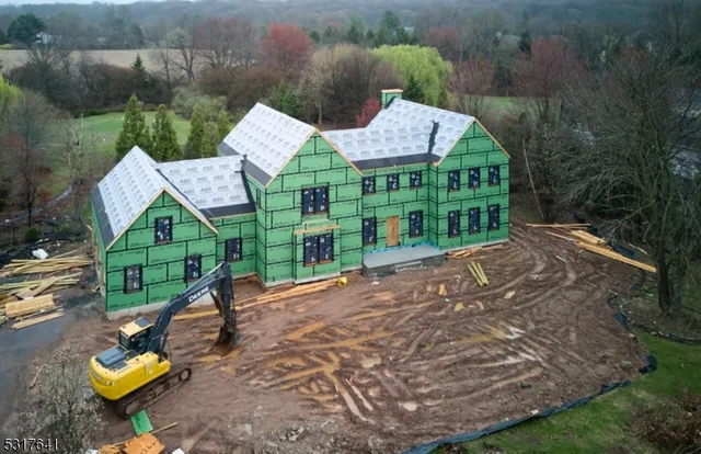 an aerial view of a house with garden space and street view