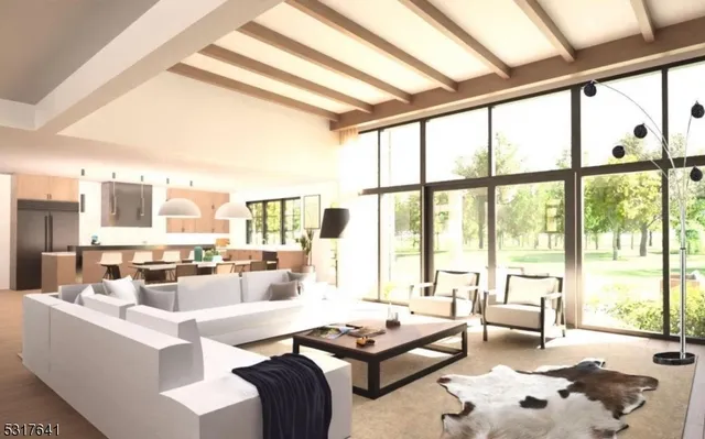 a living room with furniture and floor to ceiling windows